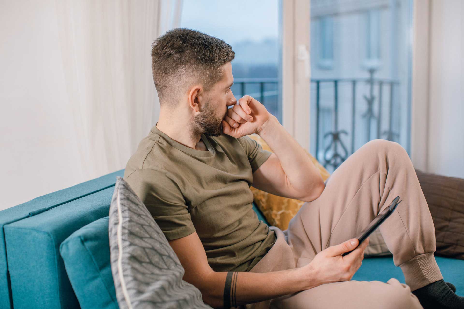 Man sitting on couch in deep thought
